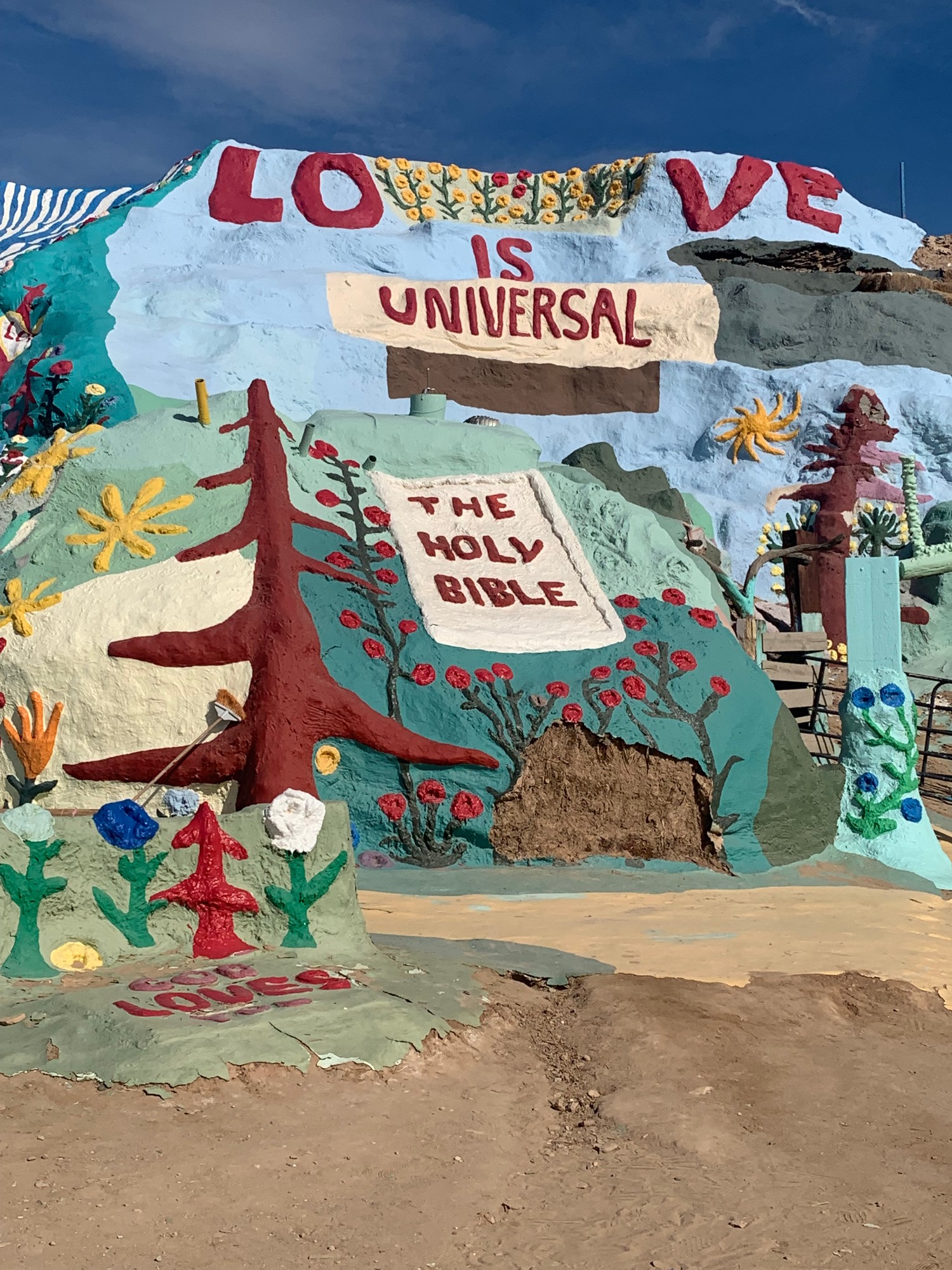 The LOVE IS UNIVERSAL and The Holy Bible murals painted into Salvation Mountain