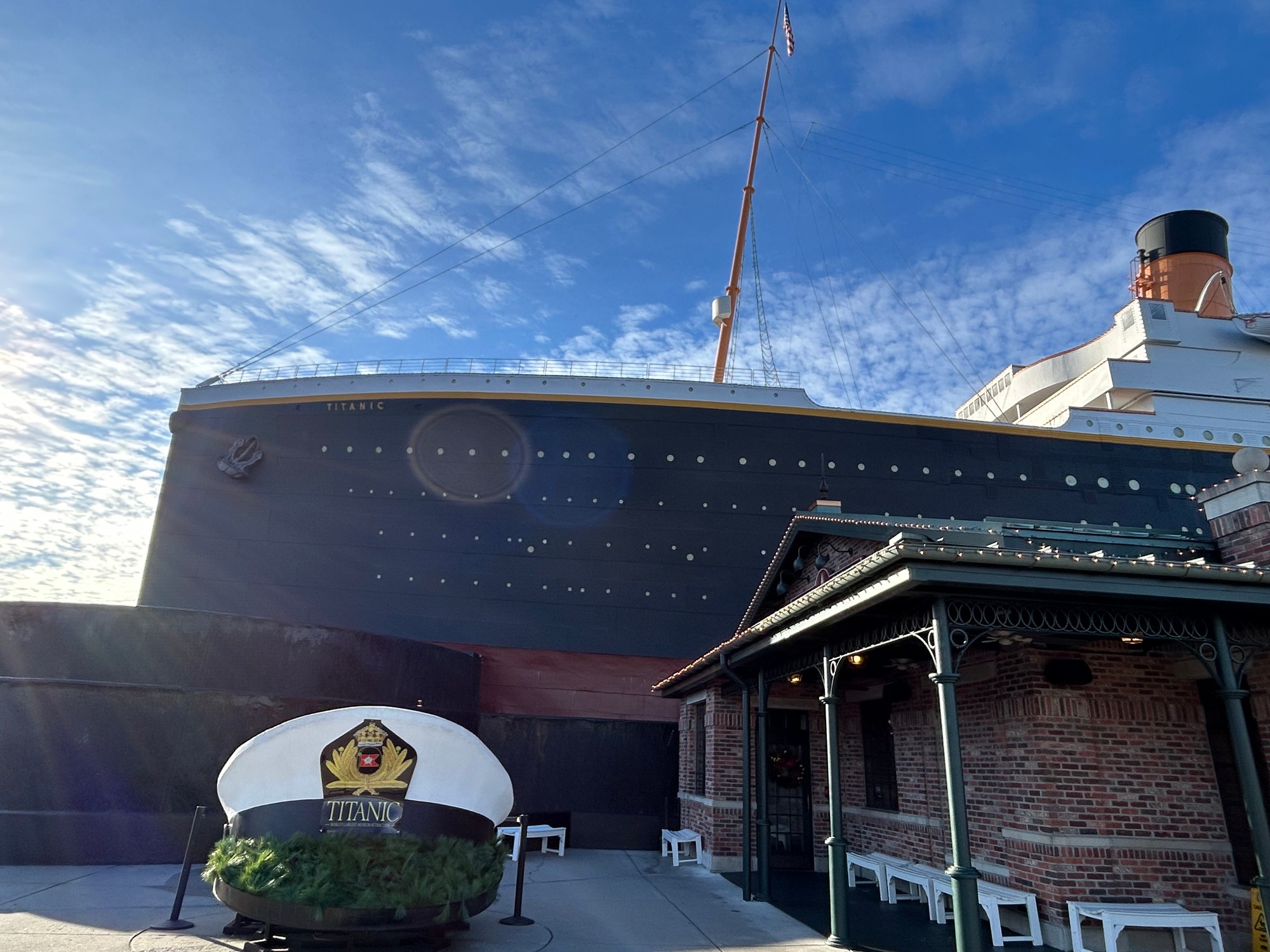 The giant captain's hat outside the Titanic attraction in Pigeon Forge, with the ship's bow behind