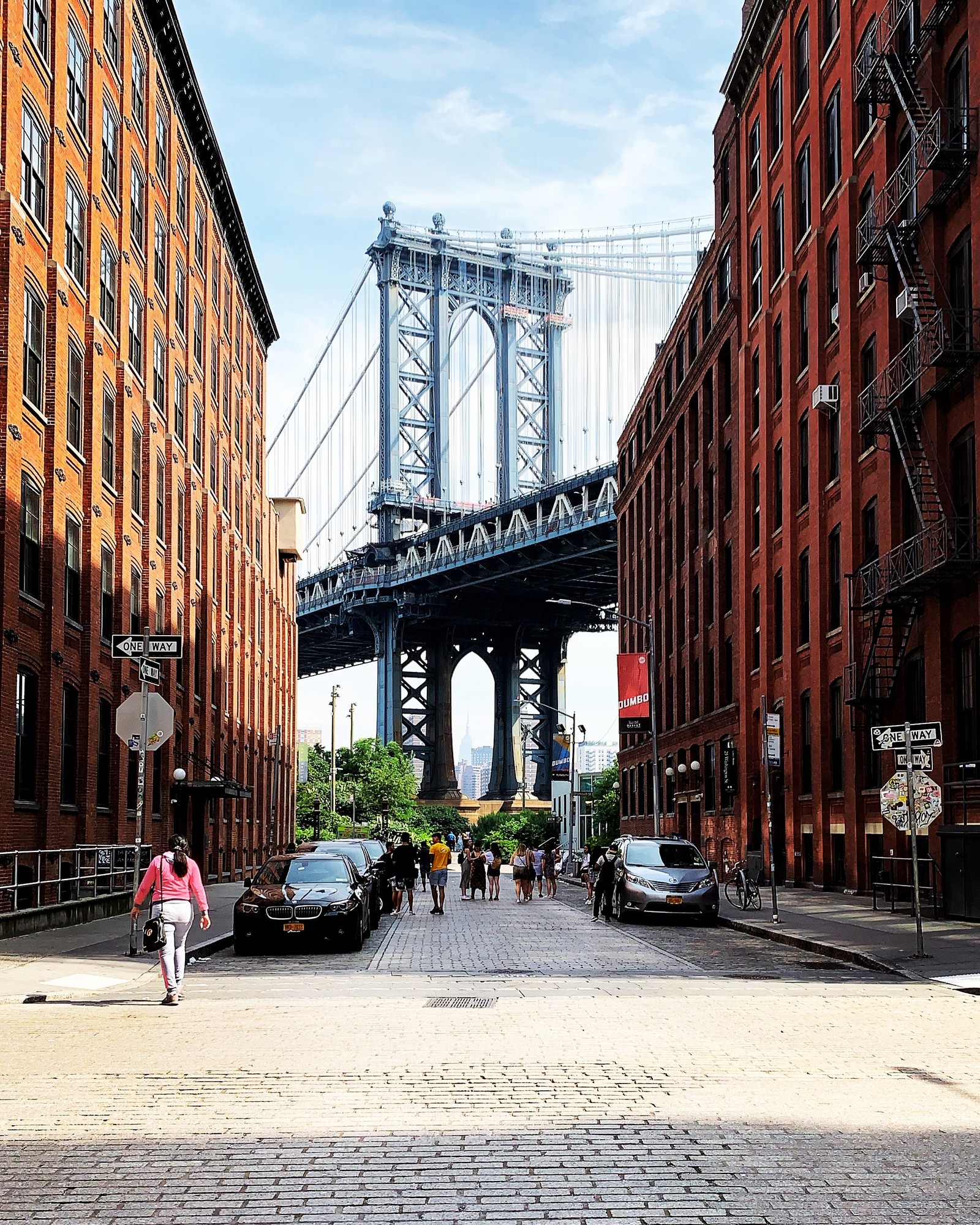 The Manhattan Bridge framed by the brick buildings of Washington Street in DUMBO, Brooklyn