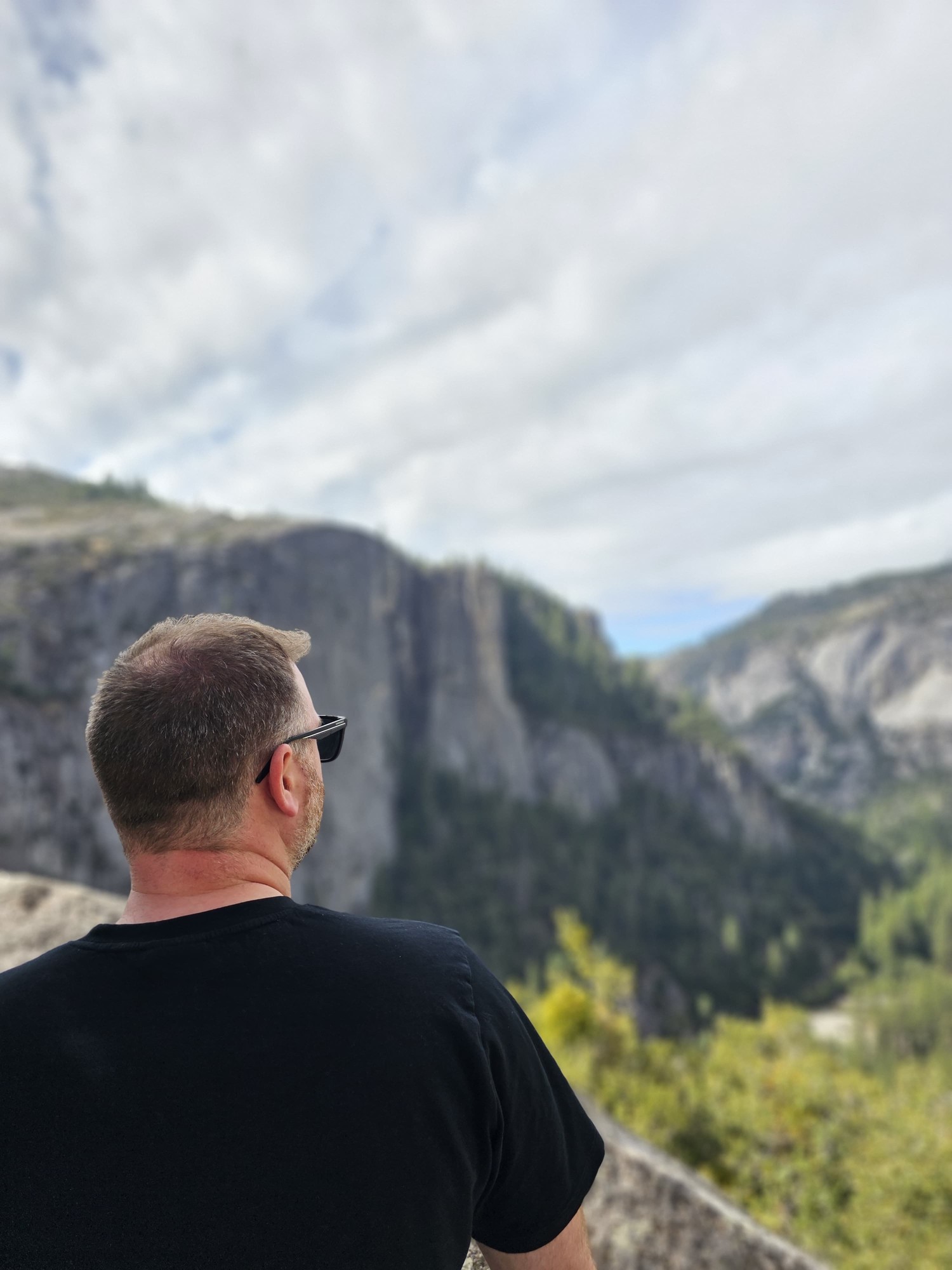 Me sitting at Glacier Point looking out over Half Dome and Yosemite Valley