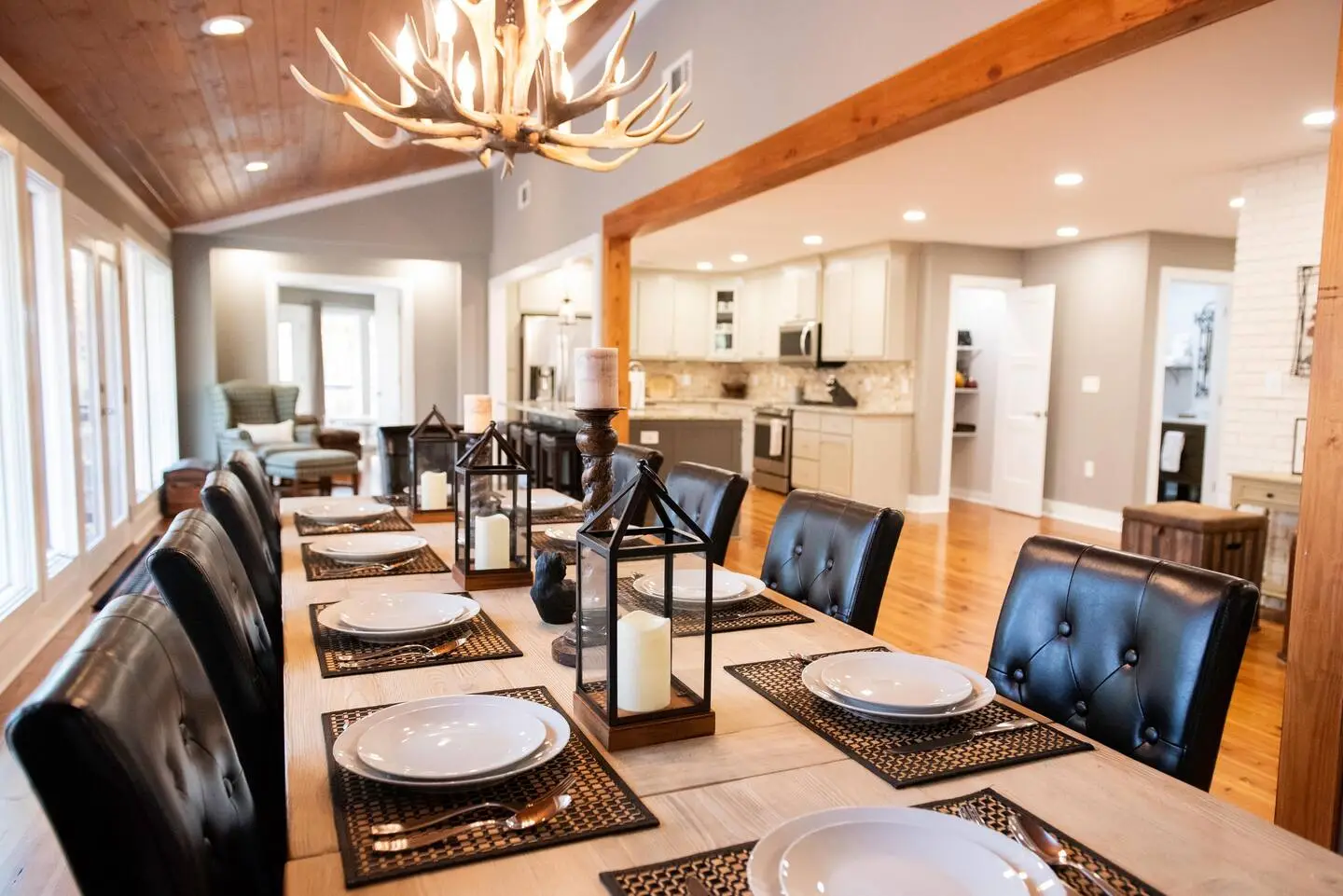 Elegant dining room with antler chandelier and modern furnishings