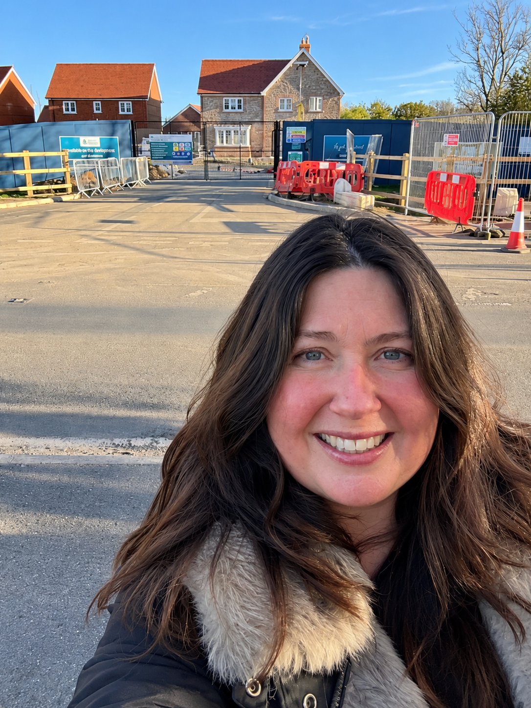 Meryl, founder of Foundation Women, smiling on a new housing development