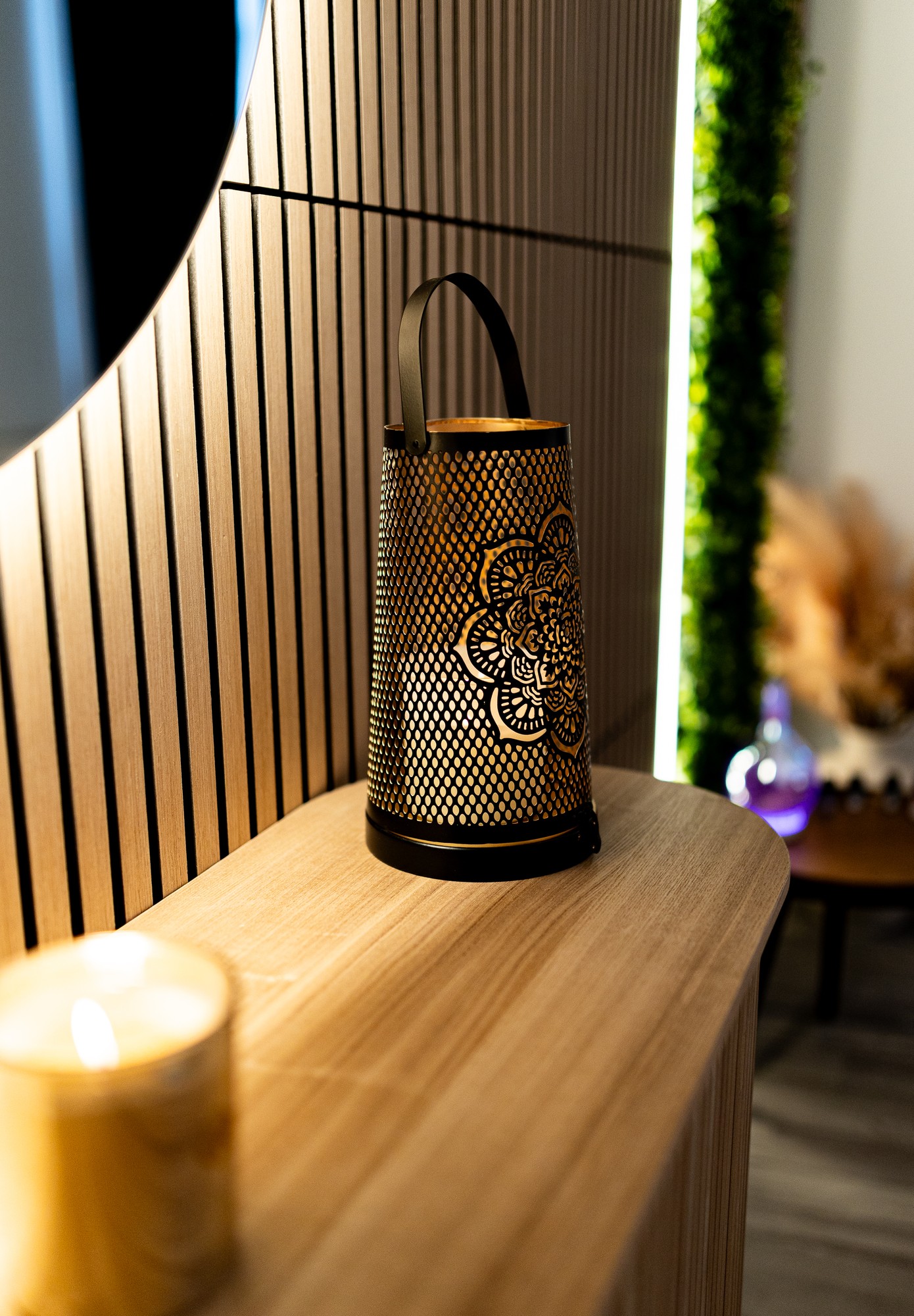 Detail interiéru MD Studio — lampa a svíčky