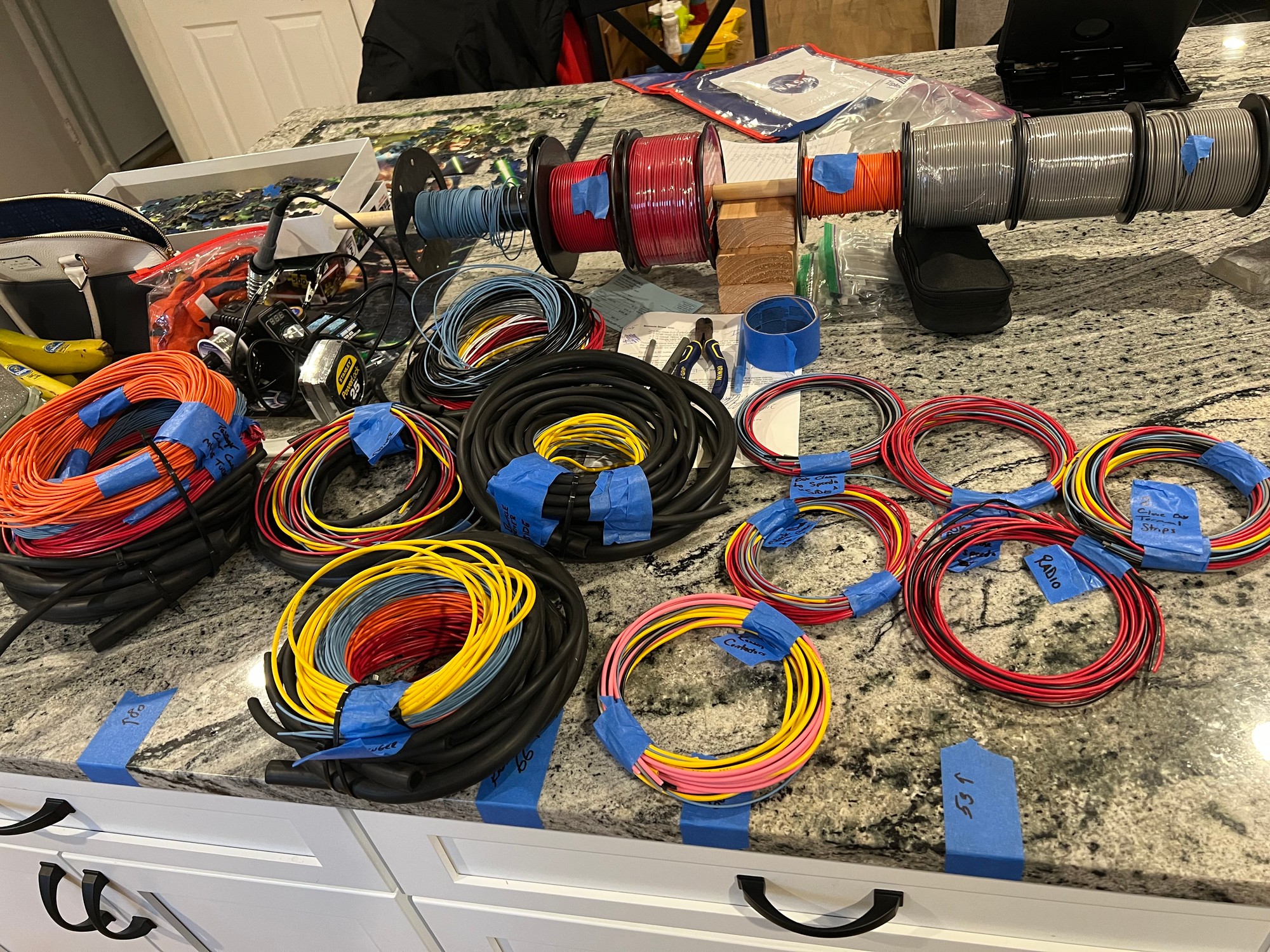 Dozens of individually labeled wire bundles — each one tagged with its destination in the car