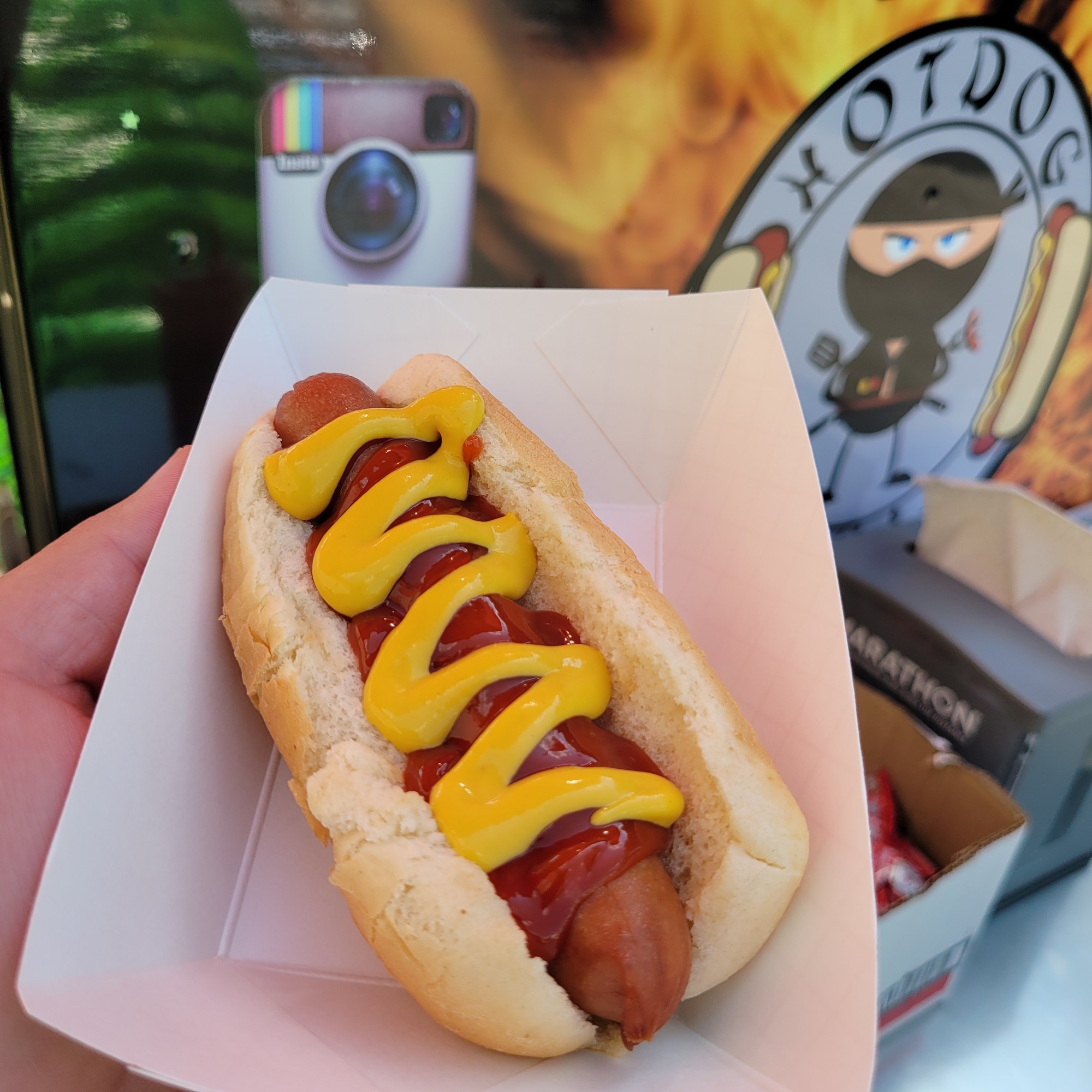 Hot Dog Ninja cart at an event with ketchup and mustard