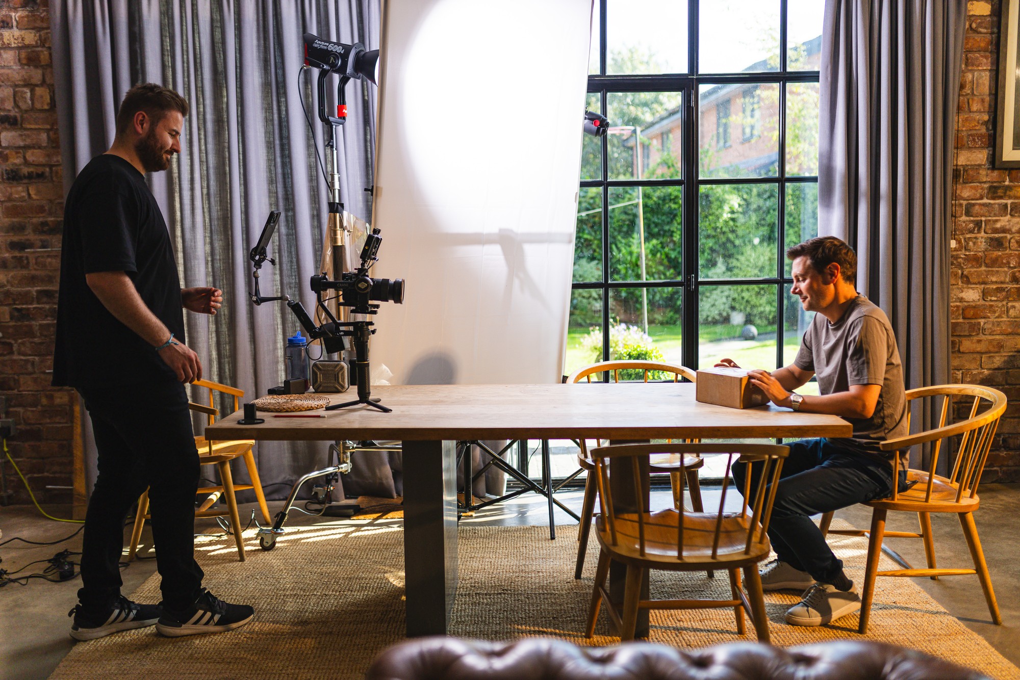 A camera operator steadies a gimbal while filming around an office