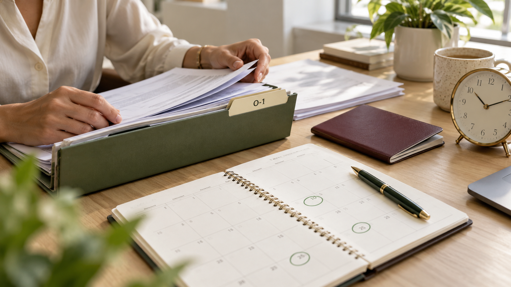 Person filing O-1 visa documents in a desk organizer next to a planner with circled dates and a clock, planning an O-1 visa timeline