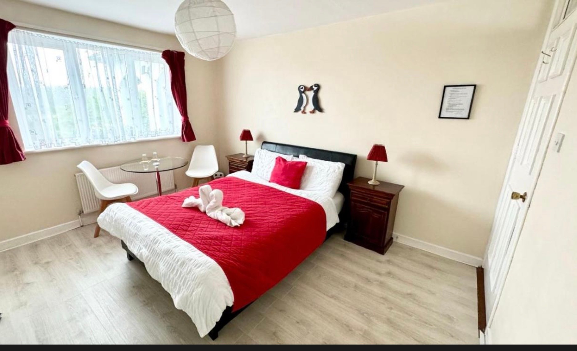 Puffin B&B double bedroom with red bedding, puffin decor and garden views