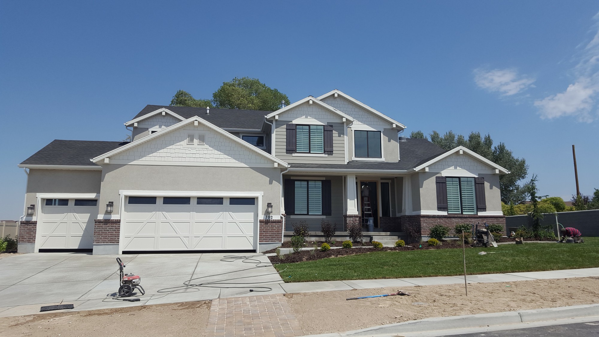 Completed custom craftsman home — stucco, brick, 3-car garage, B&N Construction