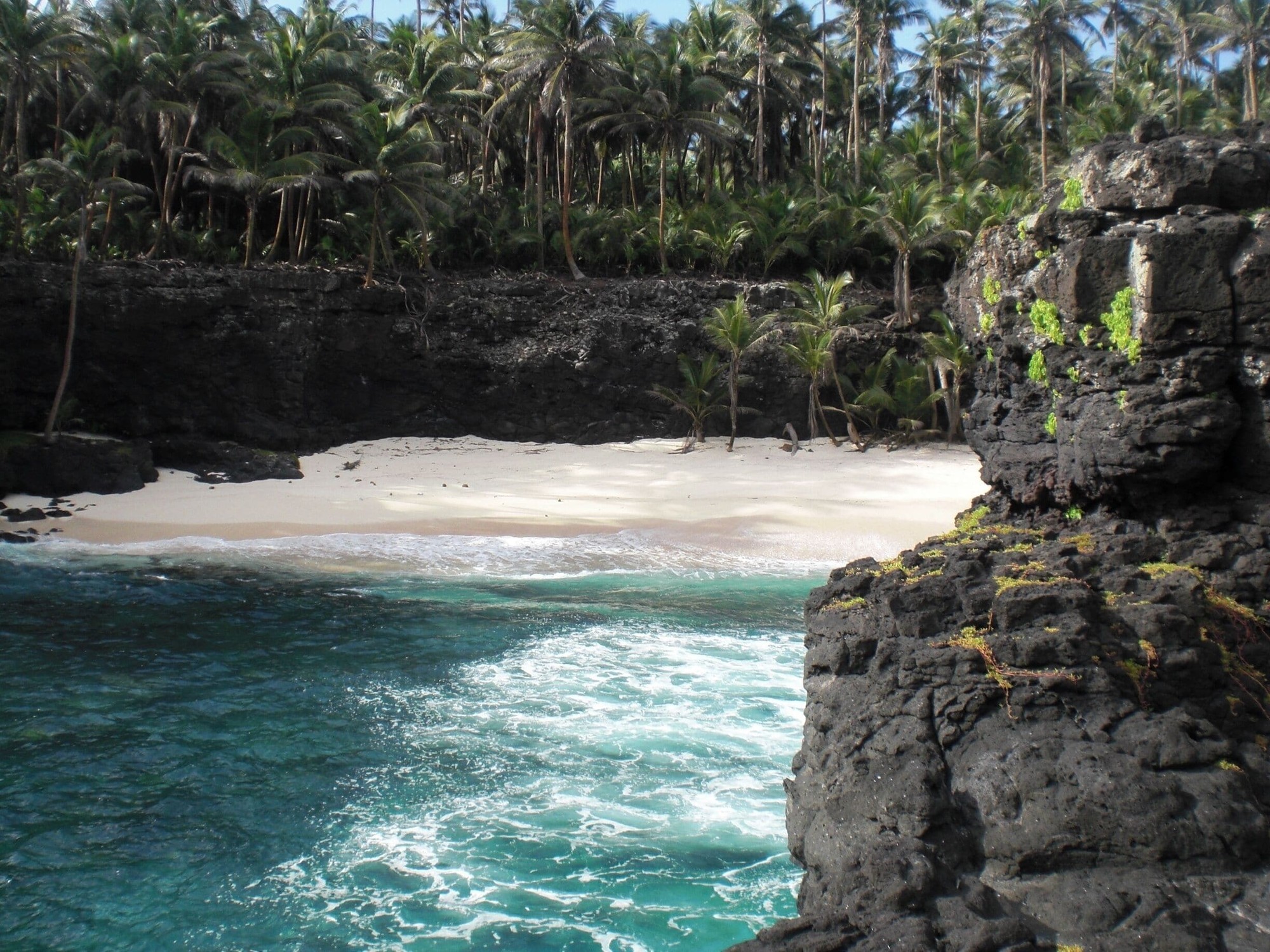Ilhéu das Rolas from above, showing the small island with its beaches and the Equator marker