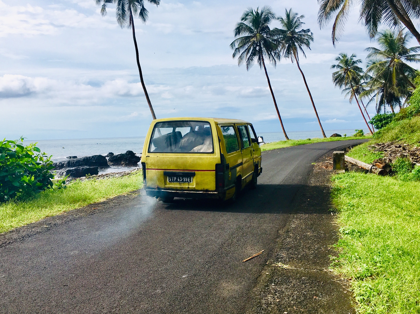 Yellow Hiace minibus passengers and street scene in São Tomé