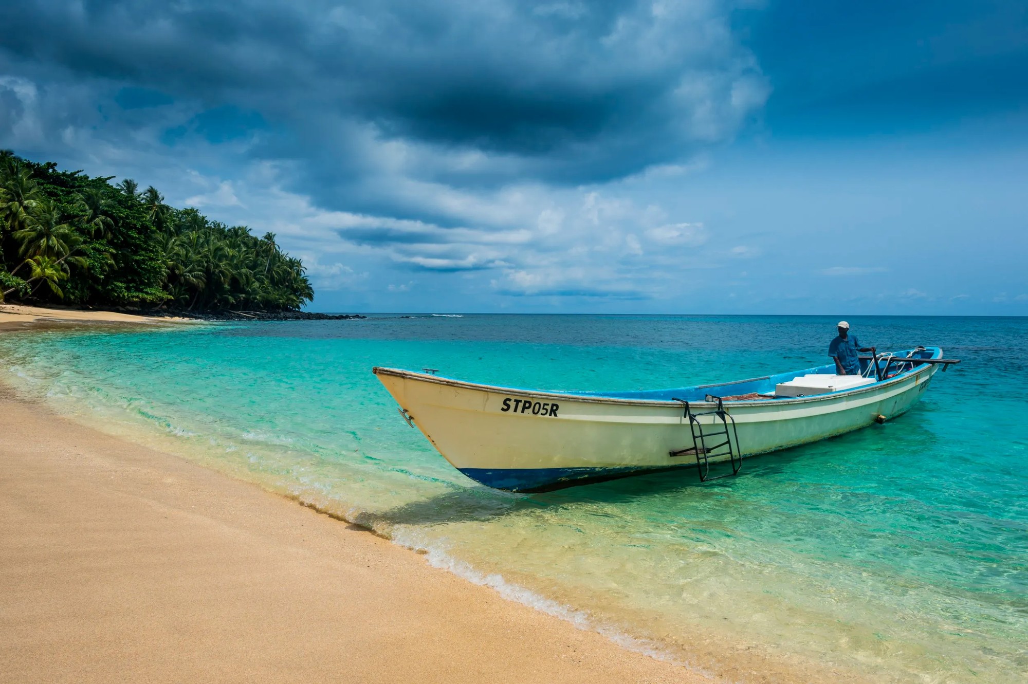 Boat trip along the forested coastline of Príncipe
