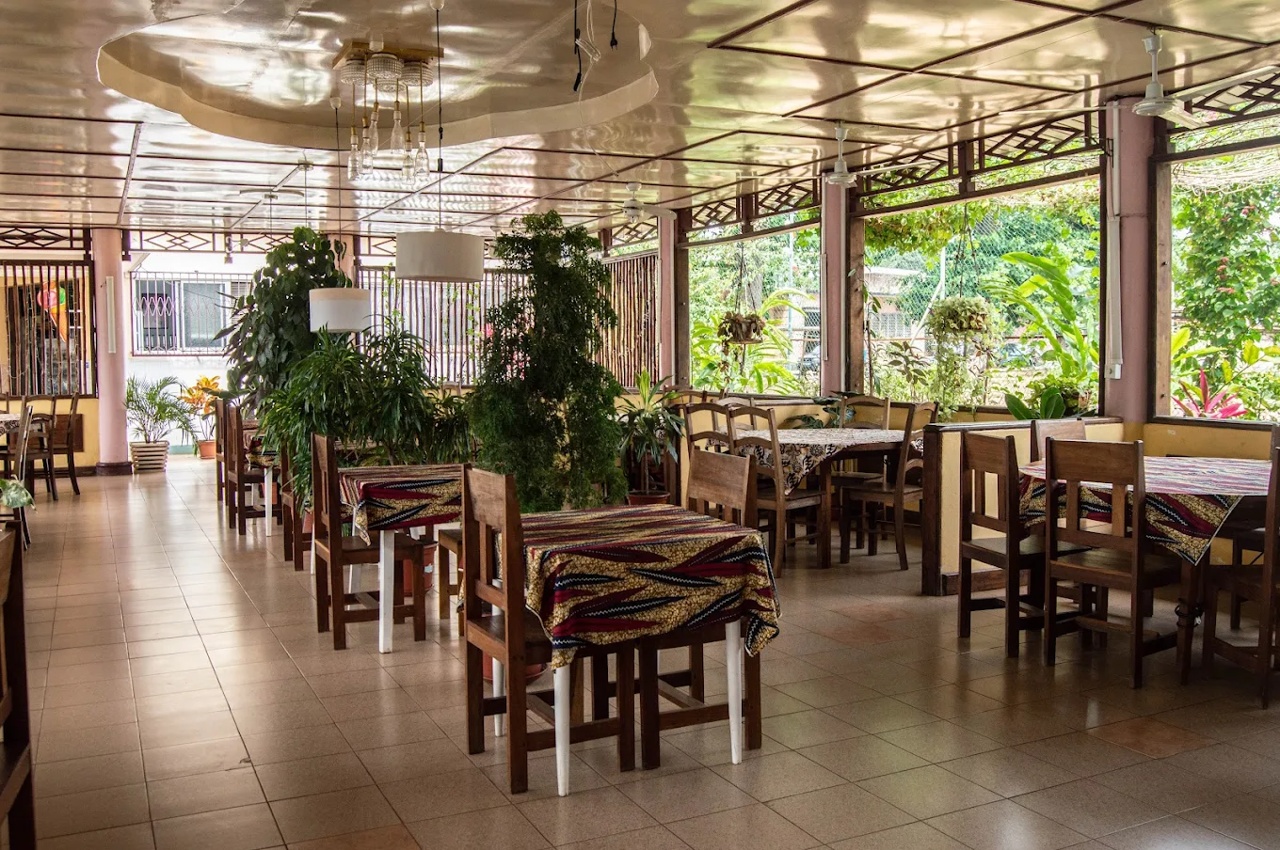 Outdoor restaurant terrace by the ocean at sunset, the kind of setting you find in São Tomé city