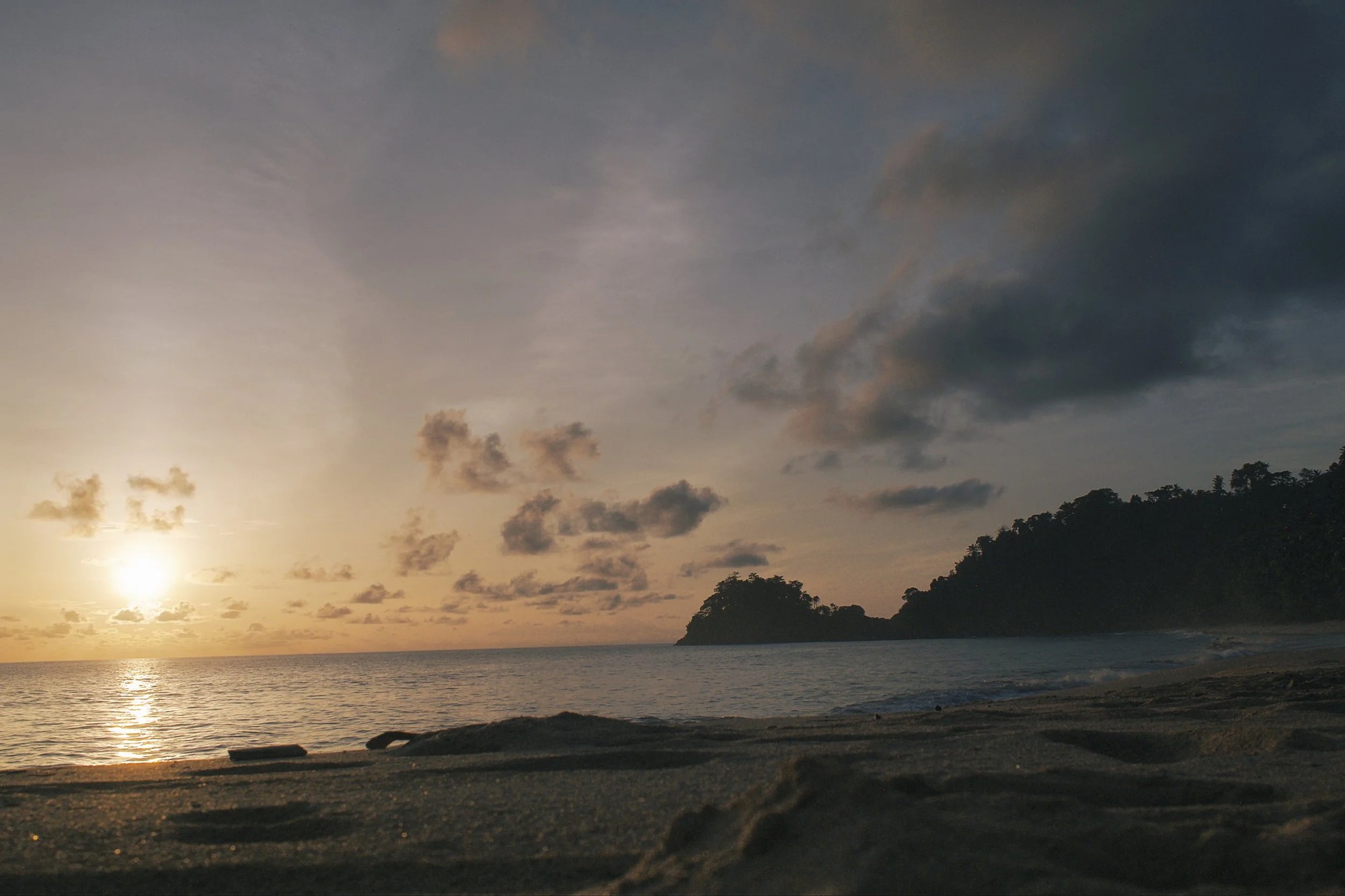 Sunset over the sea near a São Tomé headland