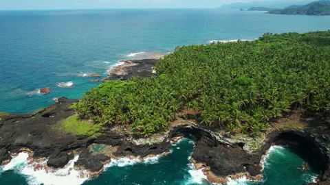 Boat approaching Ilhéu das Rolas across the channel from São Tomé