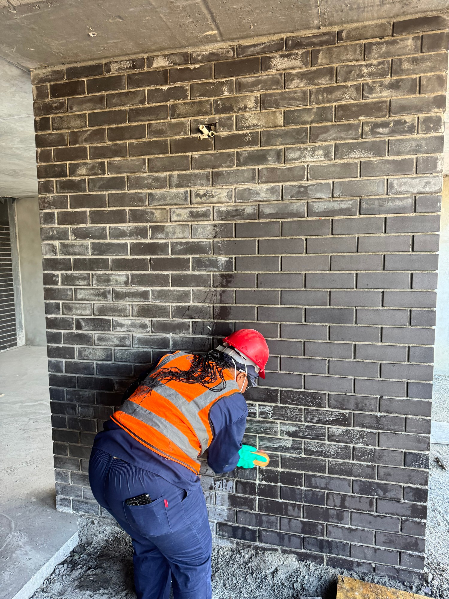Hygiene Kleen worker cleaning brickwork with safety gear
