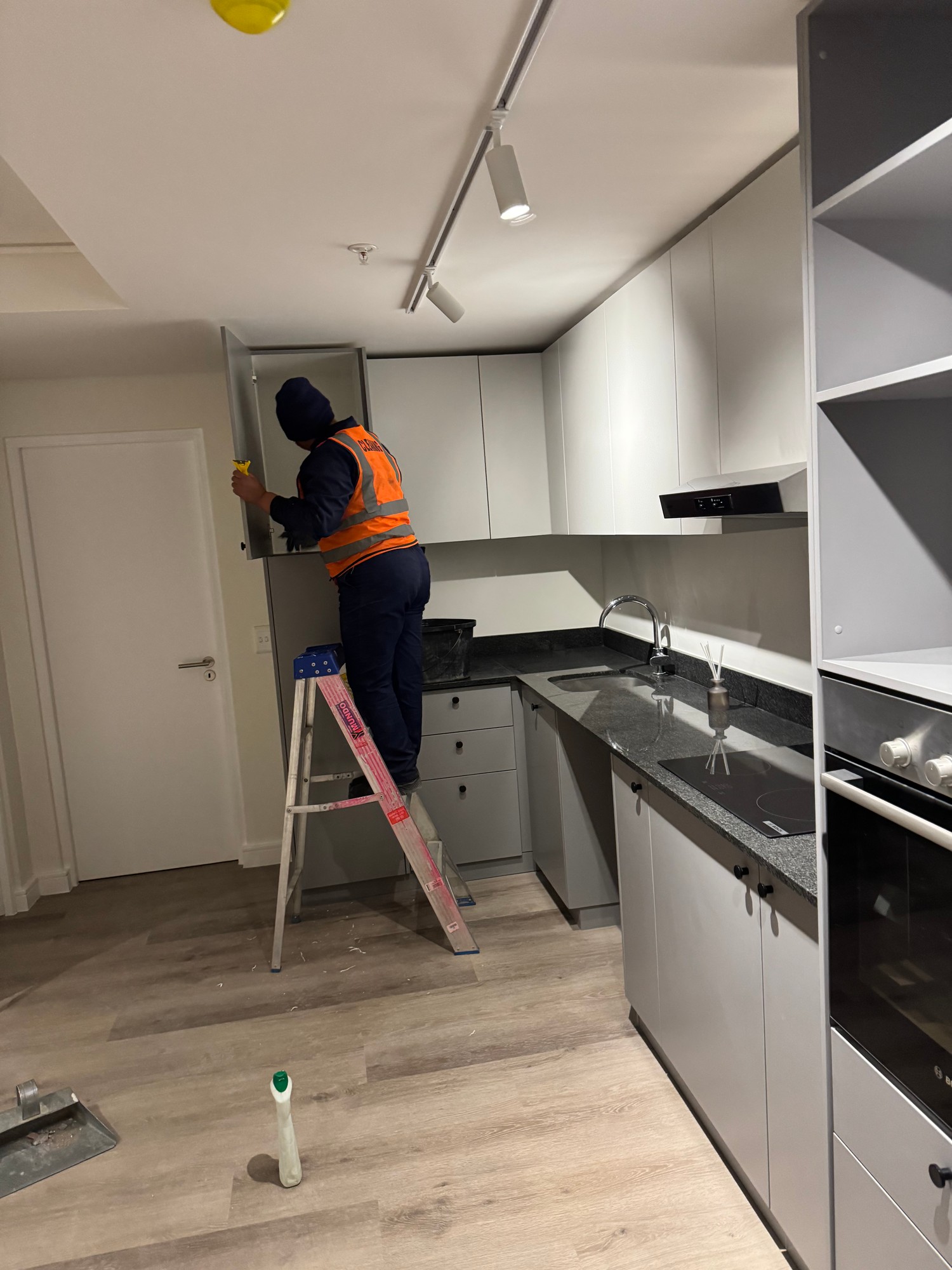 Team Cleaning Kitchen Cabinets