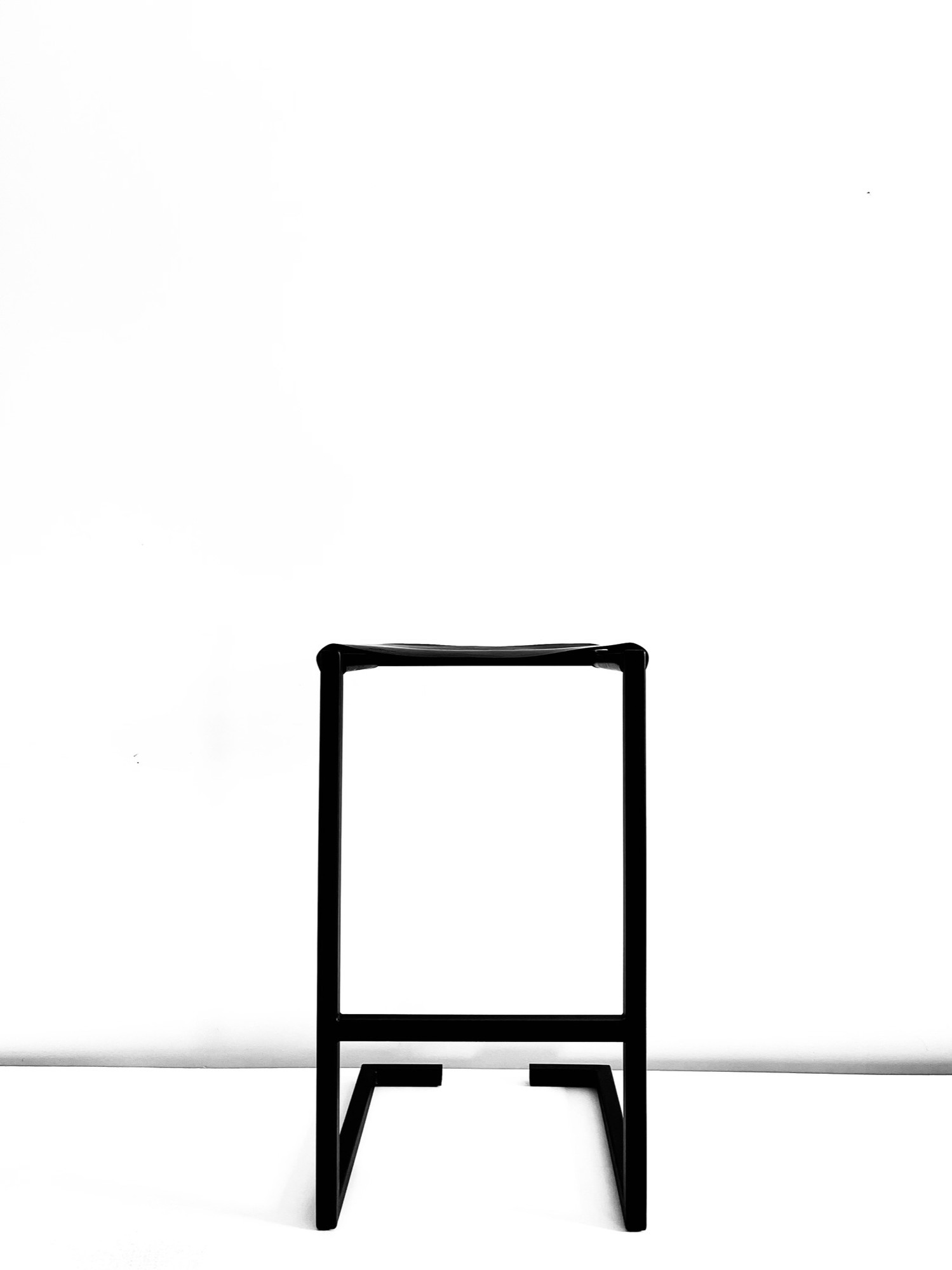 Handcrafted Design Stool detail showing the leather seat and steel frame