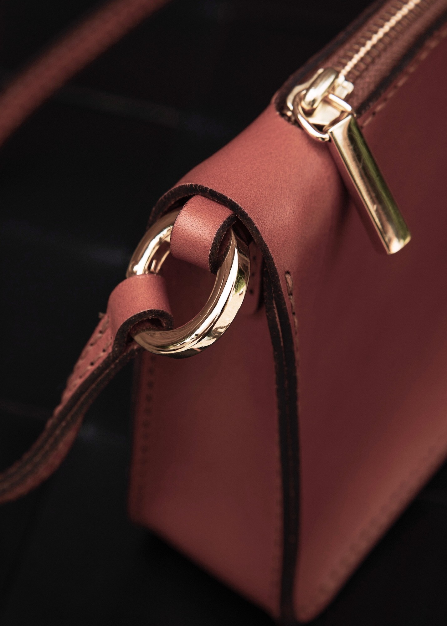 Hand-cut leather pieces and tools on the studio workbench