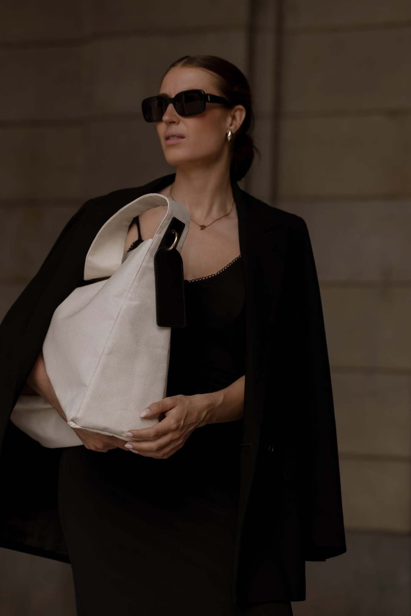 MAIIT linen tote with black leather label carried by a model