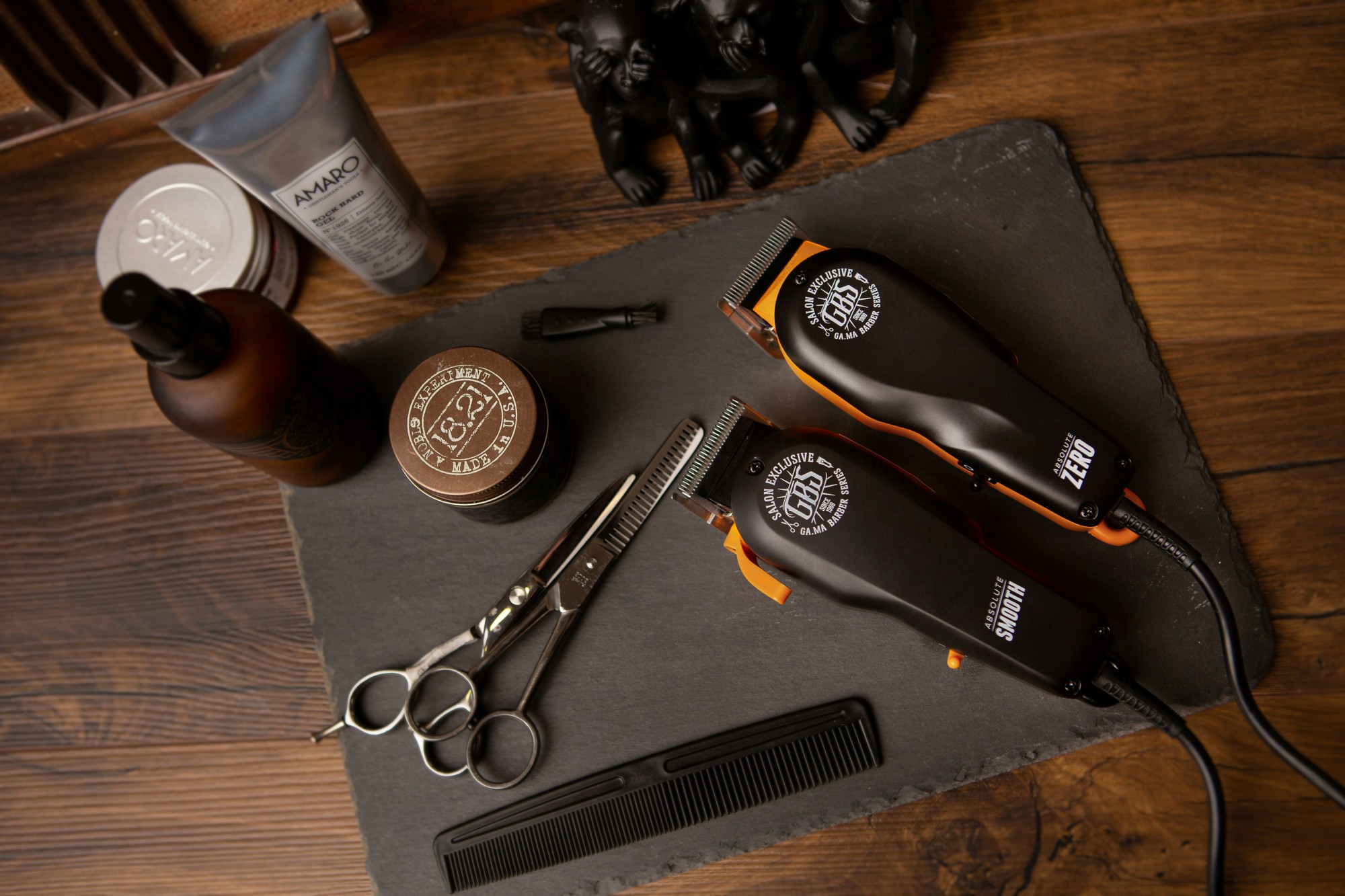 Two professional clippers with shears, comb and styling products