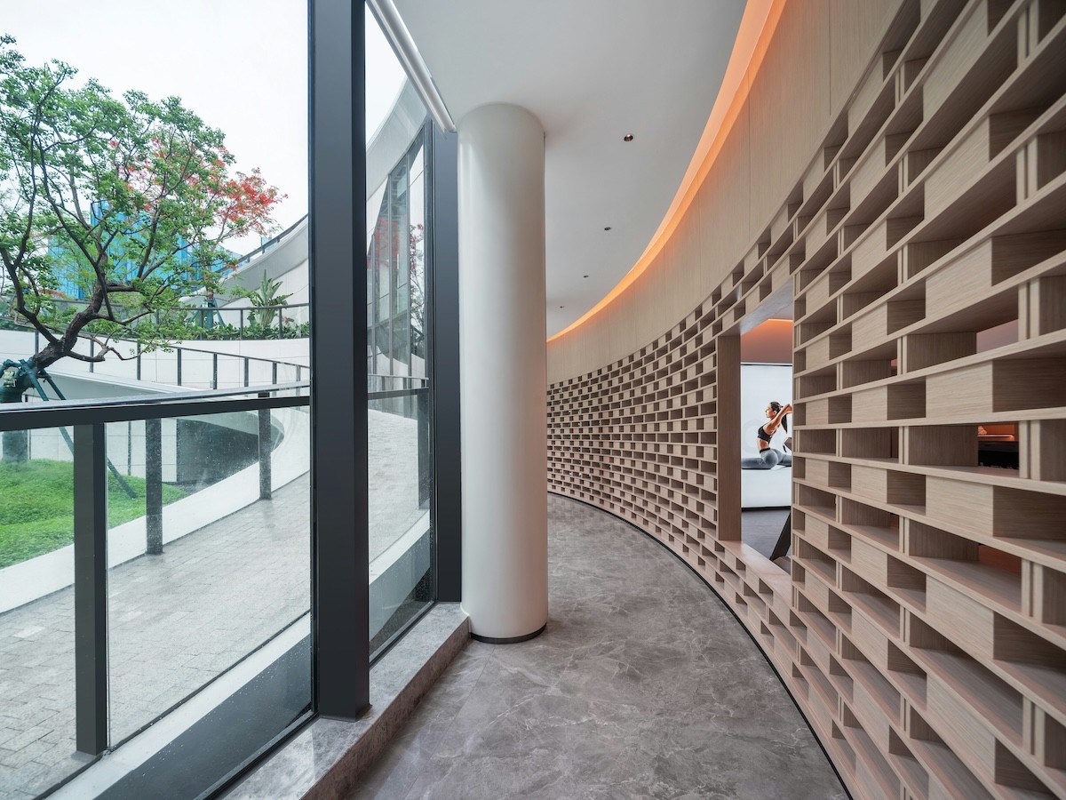 The curved timber corridor running past the practice rooms, with the garden on one side