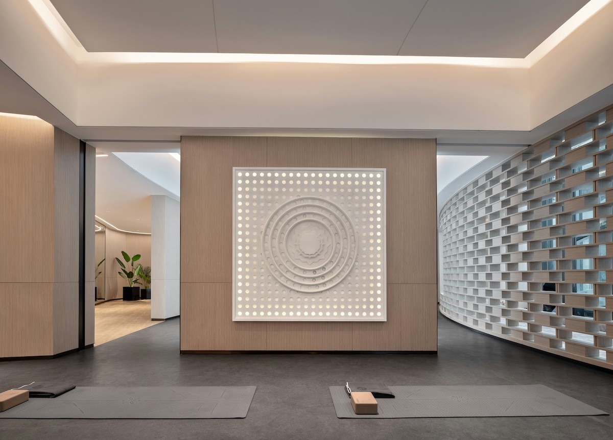 The lit relief panel in the practice room, with mats laid out in front of it