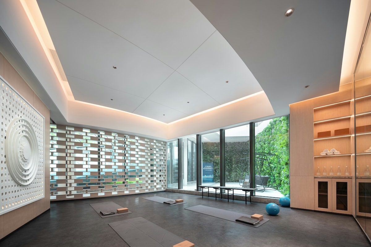 Mats set out in the practice room, open to the planted terrace