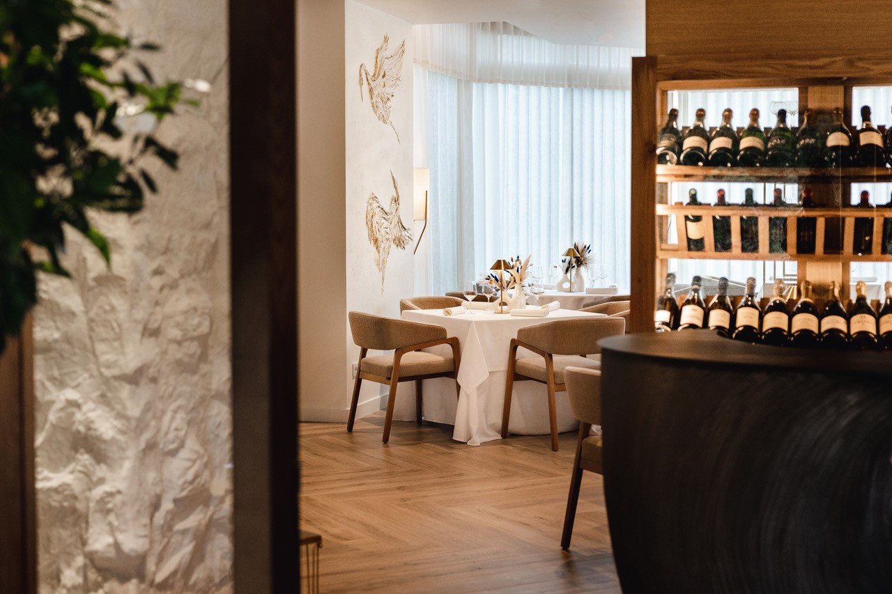 A quiet view into the dining room and wine display at El Lago, Marbella