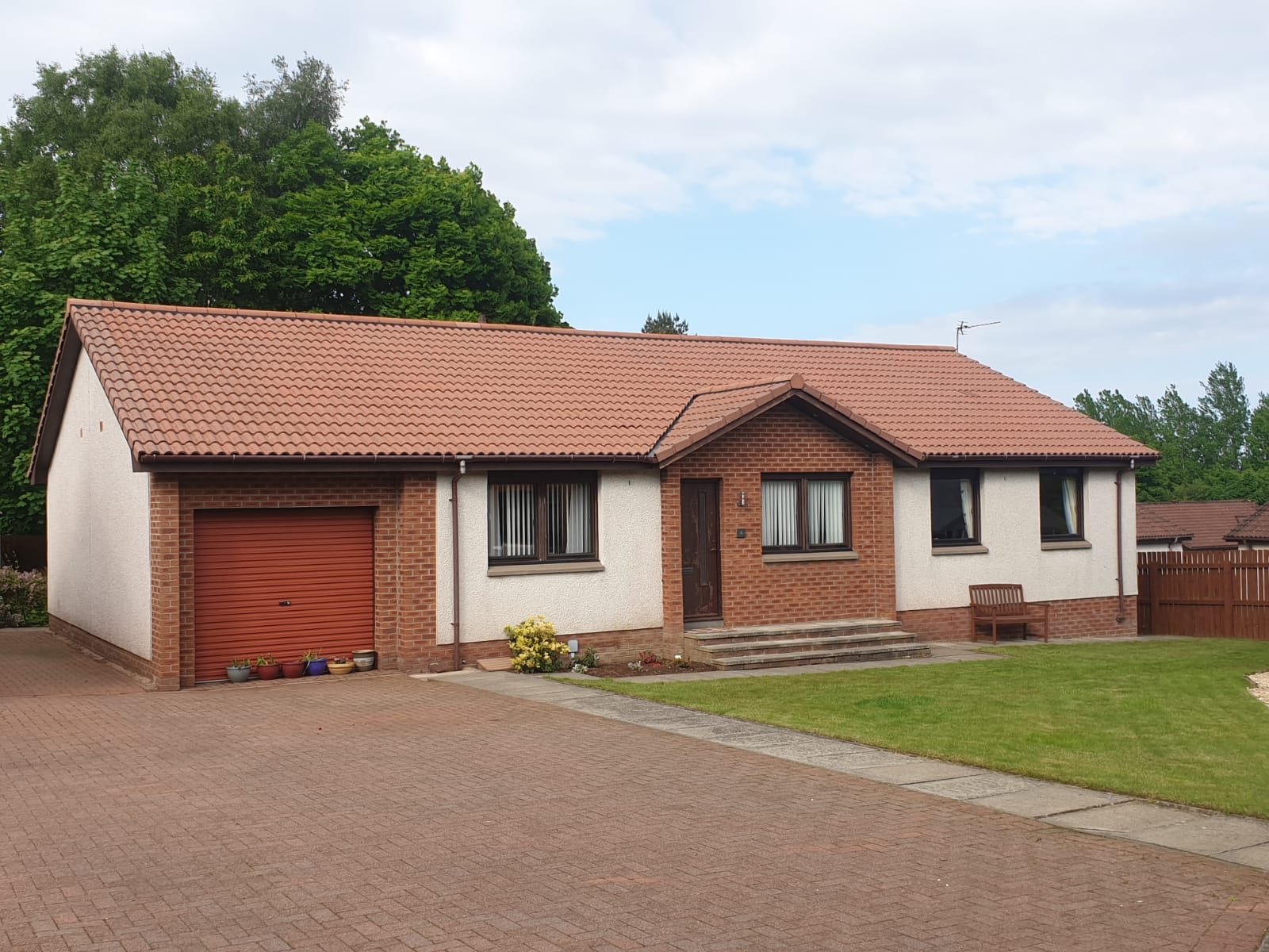 Bungalow roof after professional roof cleaning and moss removal — clean restored tiles, Perthshire