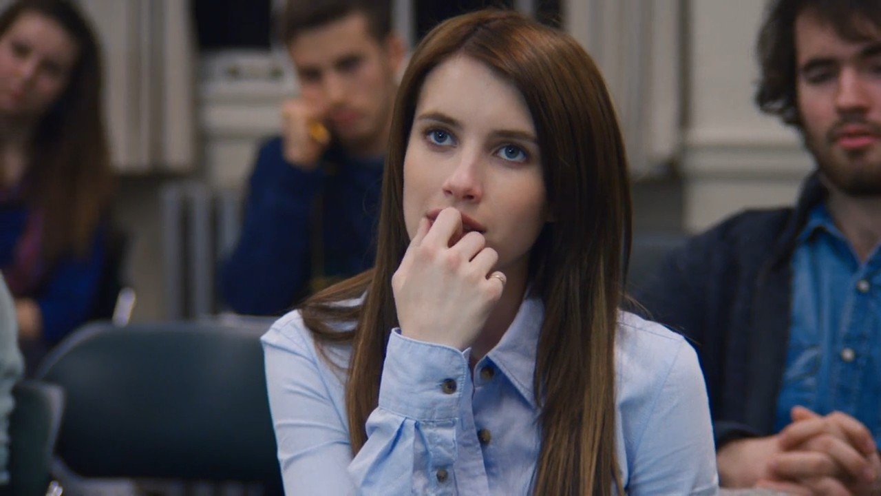 A student listening intently in a classroom scene from Restless Virgins