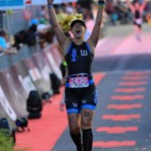Coach Jessica Baxter crossing the IRONMAN finish line — TriDot Founding Master Coach and Kona qualifier