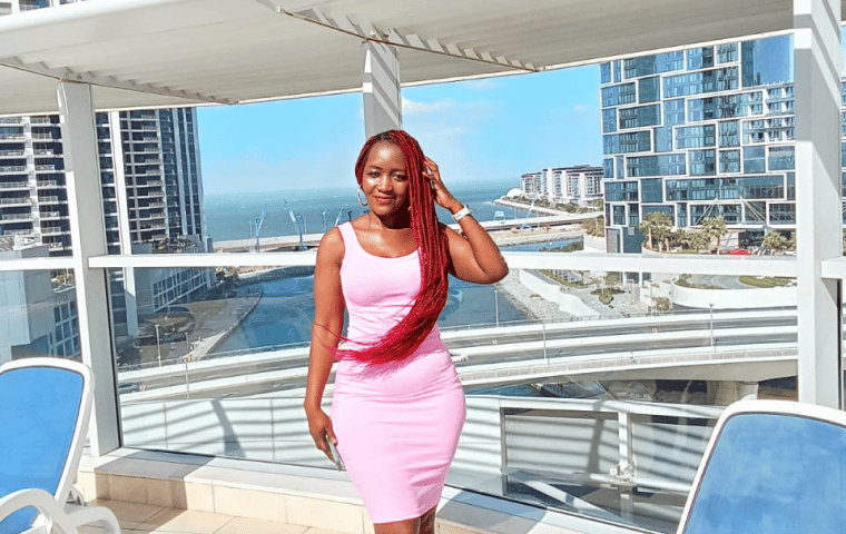 Freda on a rooftop terrace overlooking the sea in the UAE