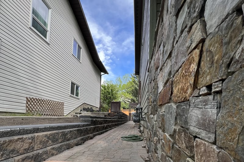 Natural stone retaining wall close-up by All The Moore Landscaping Calgary