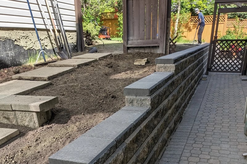 Retaining wall and cobblestone patio being constructed in Calgary