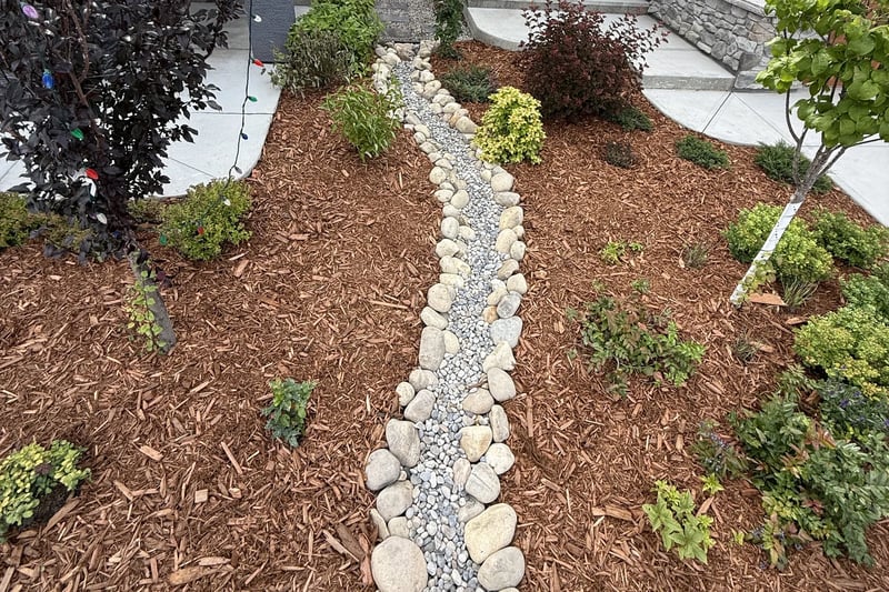 Path lights and river rock landscaping illuminated at night in Calgary