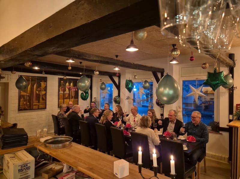 A party in the restaurant with tables set for dinner
