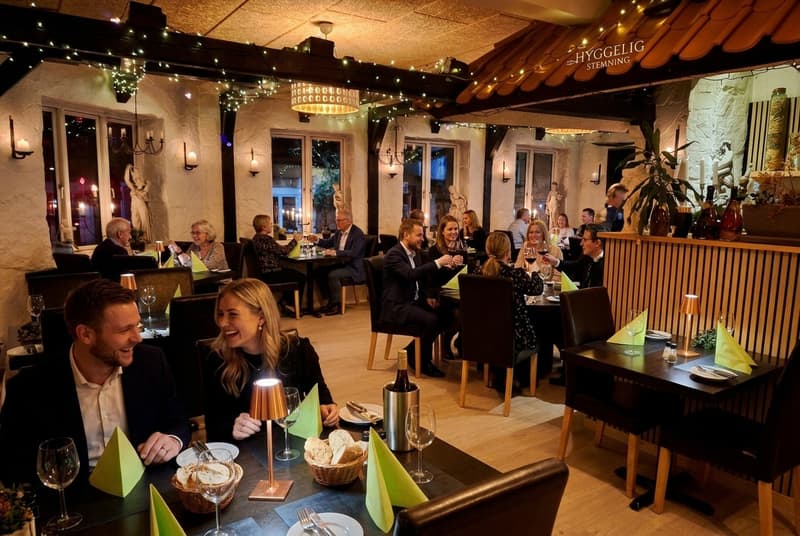 The rustic cellar with stone vaults, candles and tables set for dinner