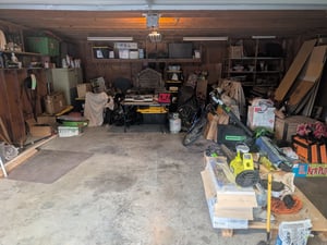 After: the same two-car garage emptied, sorted, and swept clean