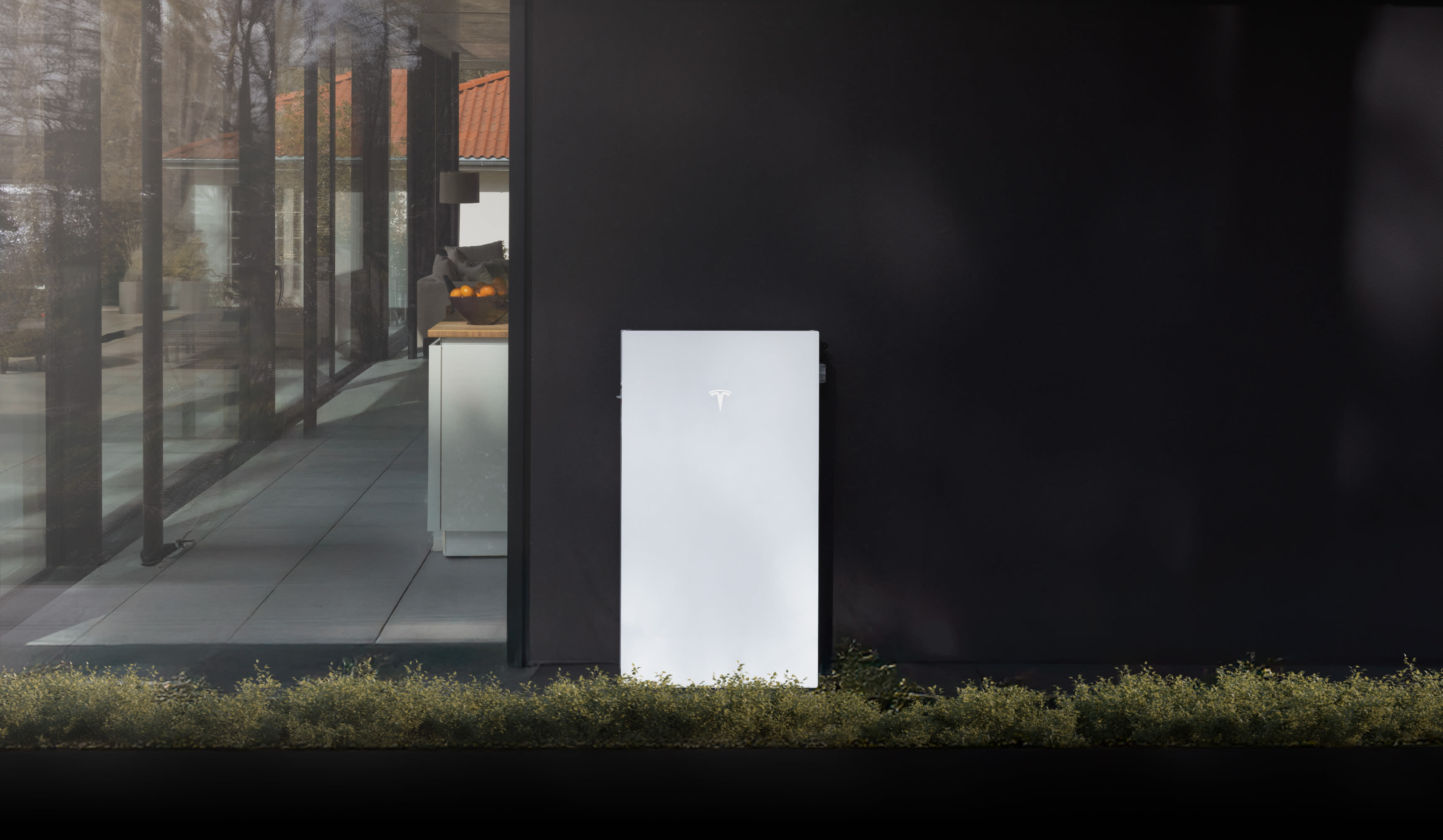 Tesla Powerwall 3P geplaatst langs de gevel van een moderne woning