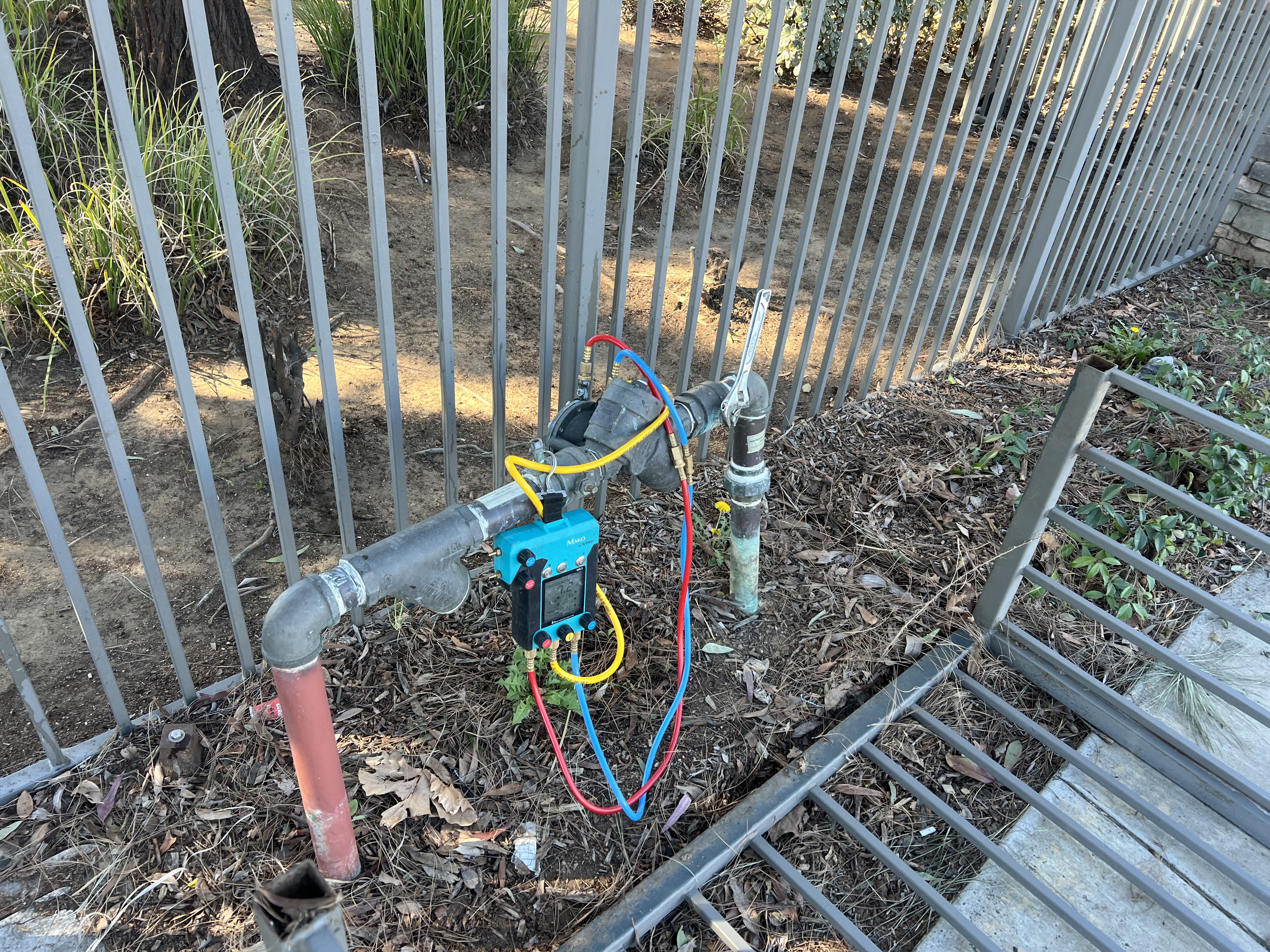 Backflow preventer assembly being tested with Mako gauge at a commercial property in Riverside, CA