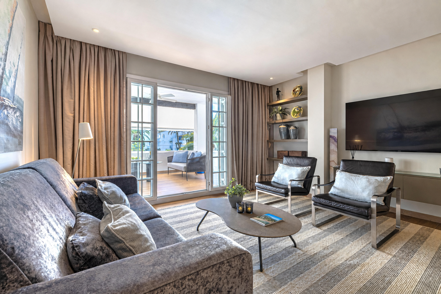Bright living room opening onto the apartment terrace