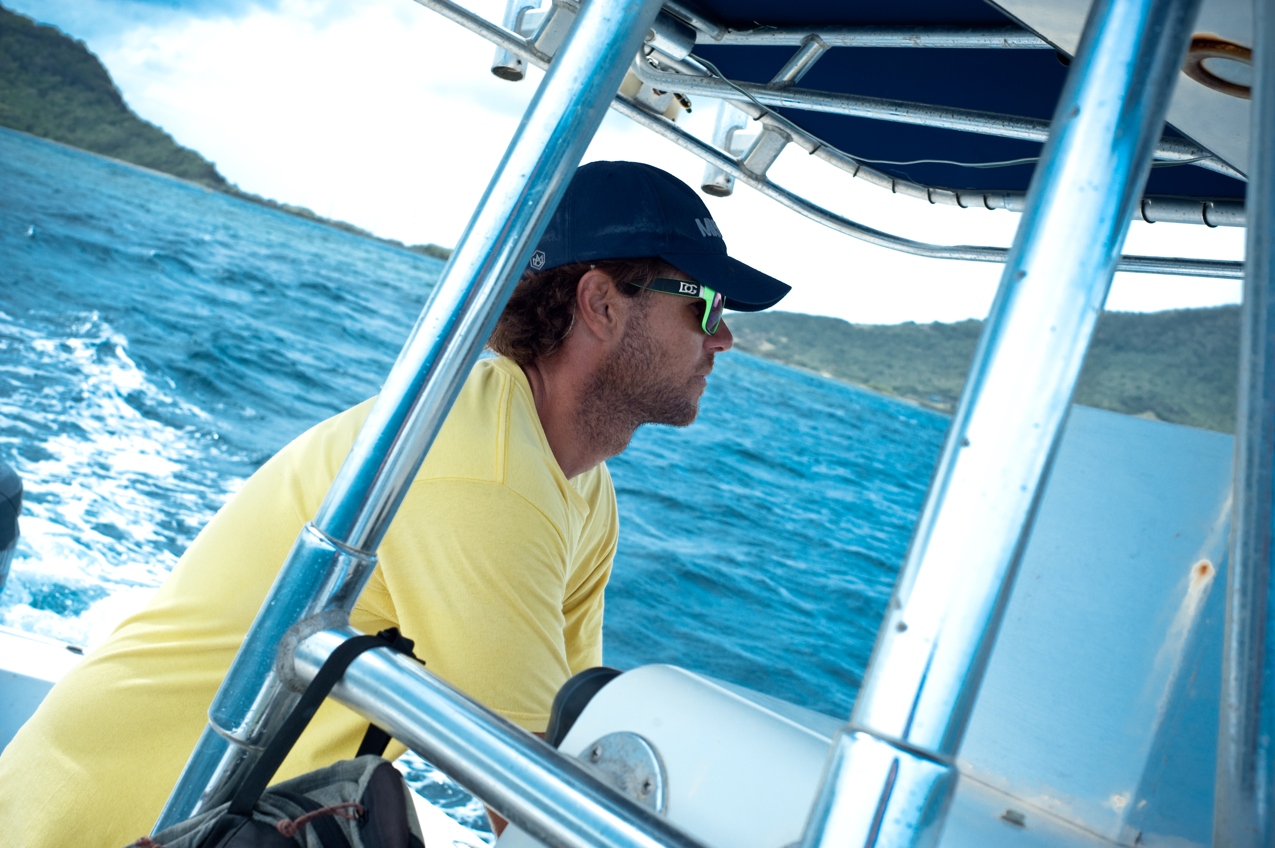 Captain Sebastien at the helm, scanning the water for fish