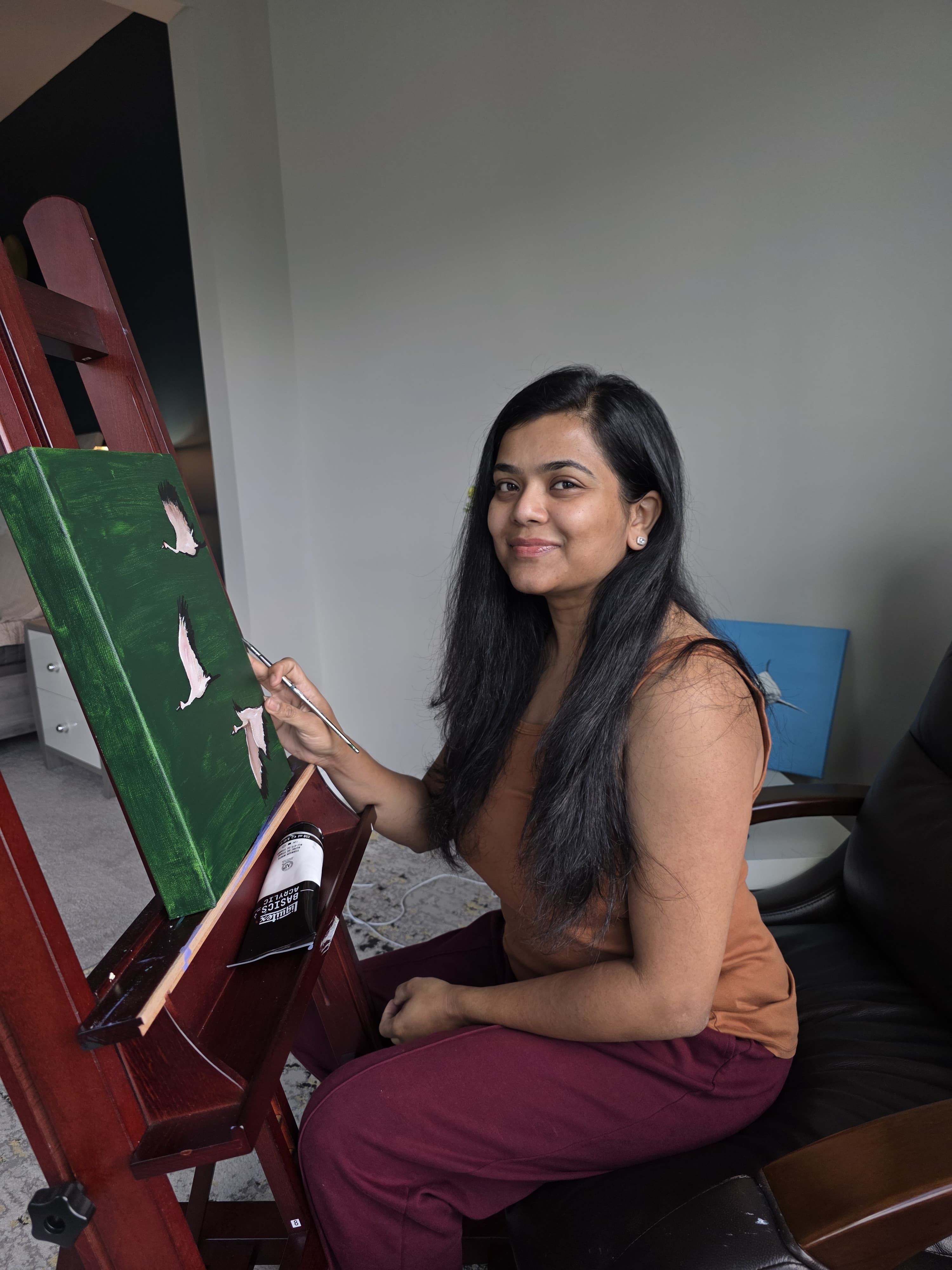 Megha painting in her home art studio with natural lighting