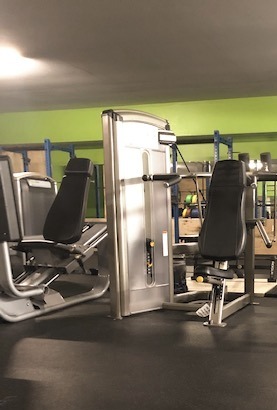 Selectorized strength machines on the training floor at The Box