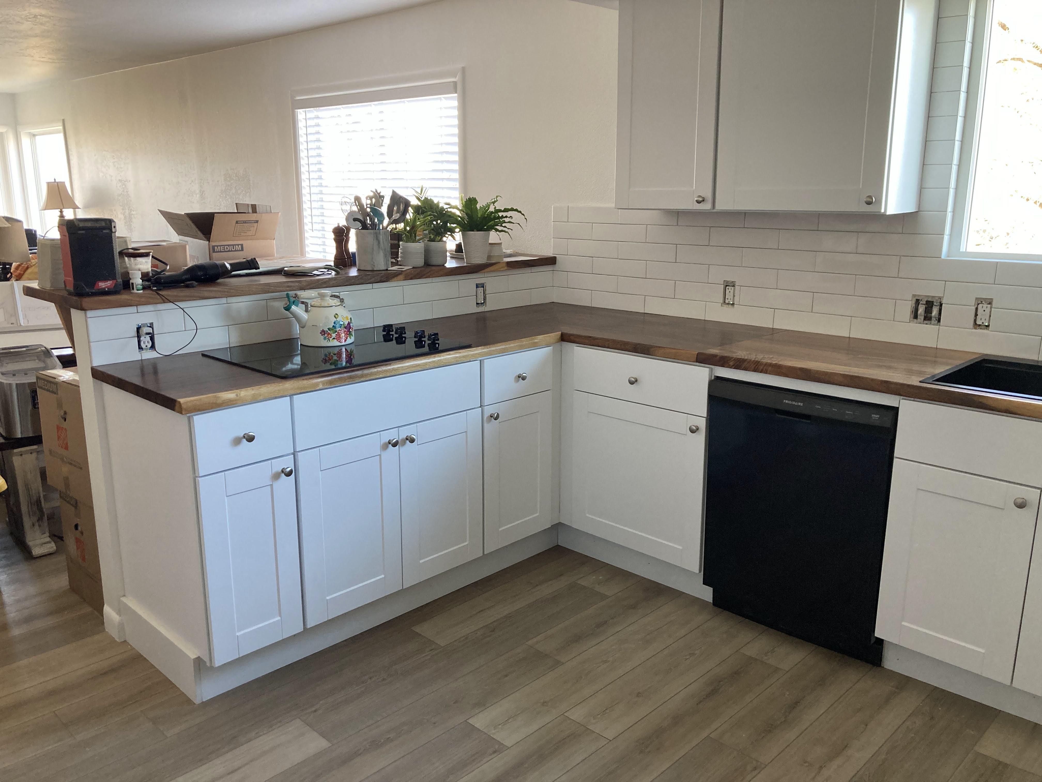 Kitchen remodel wide view — LVP flooring, subway tile backsplash