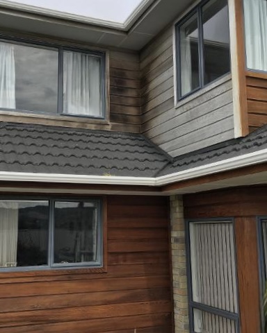 Wellington home with weathered upper cladding waiting for recoating