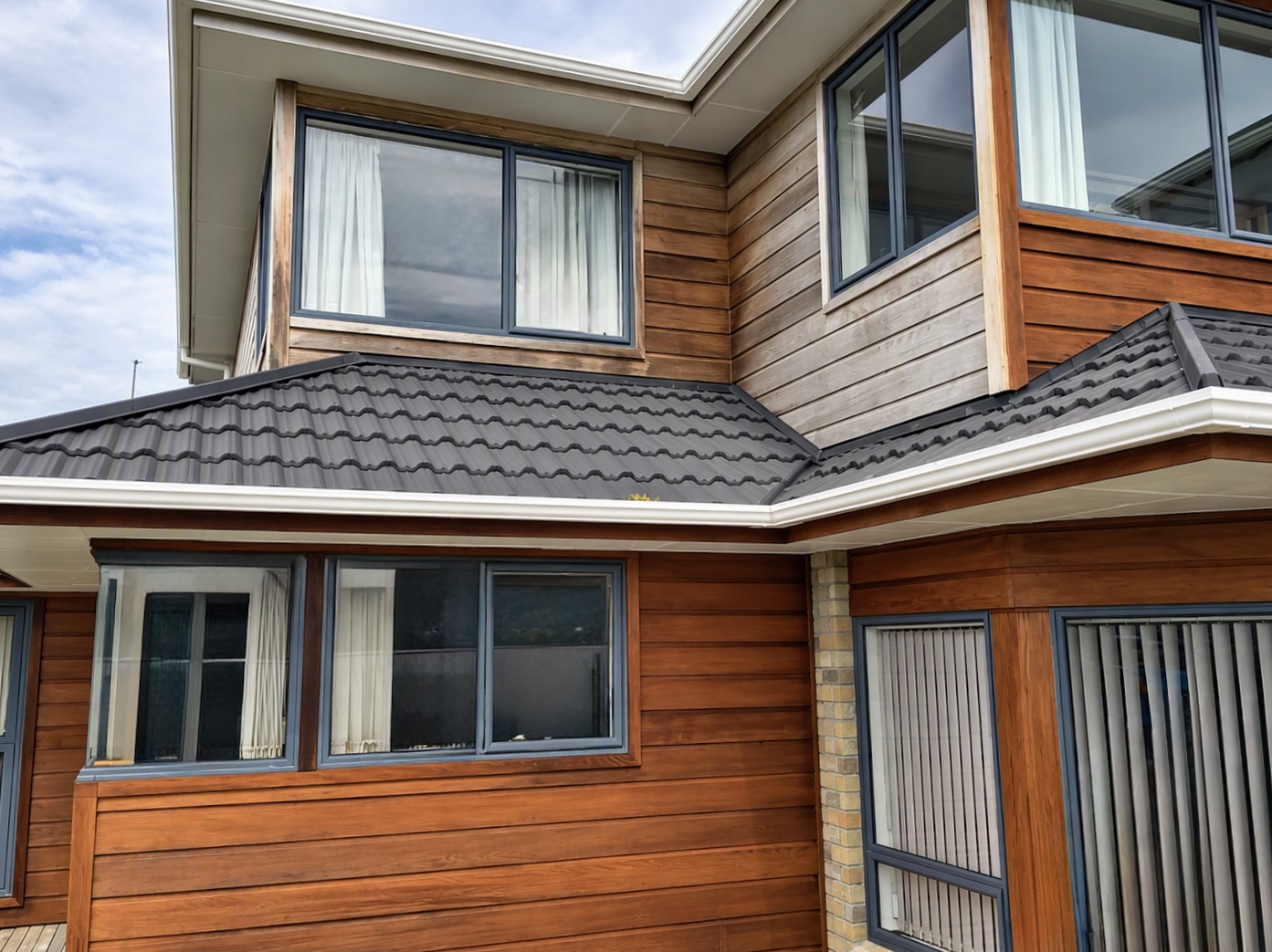 Wellington home with weathered upper cladding and freshly restained lower cedar