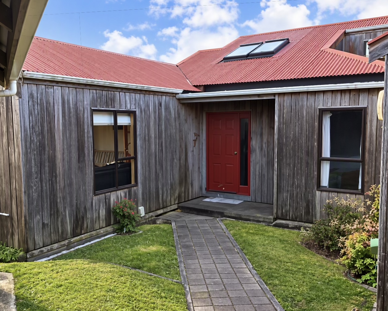 Weathered cedar cladding before restoration