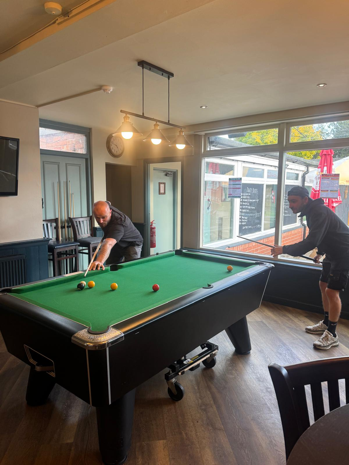 Two players mid-game on the pool table at The Star Inn